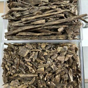High-quality Agarwood (Oud) resin wood pieces showcasing natural dark grains and aromatic texture.